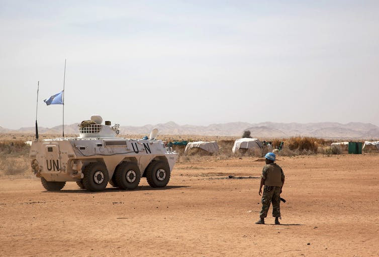 UN tank in dusty field
