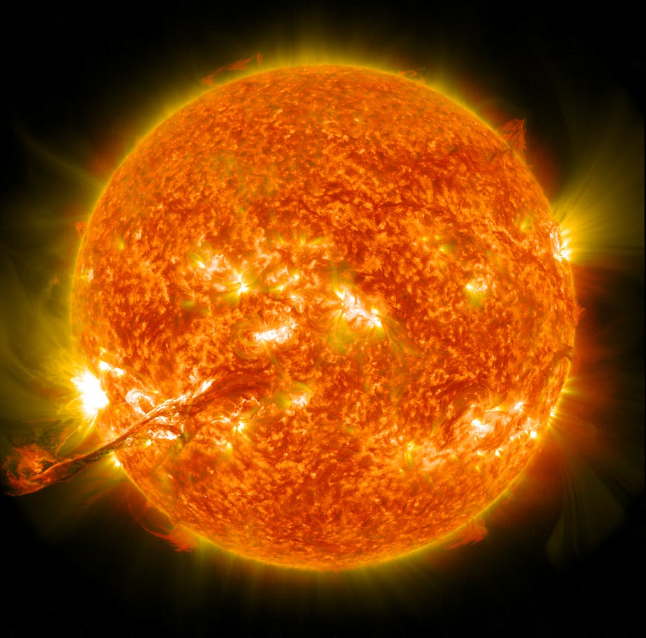A photo of the Sun with a massive finger of plasma extending from the bottom left into space.