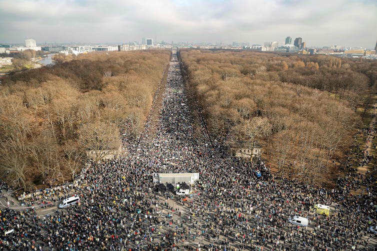 Aerial view of crowds near Berlin's Brandenburg Gate.