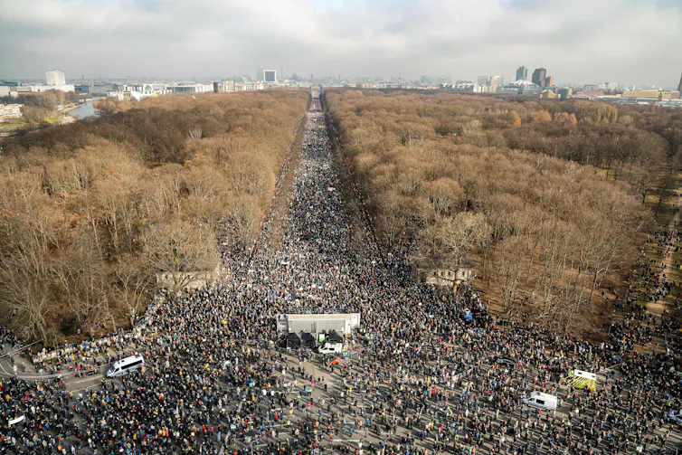 Aerial view of crowds near Berlin's Brandenburg Gate.
