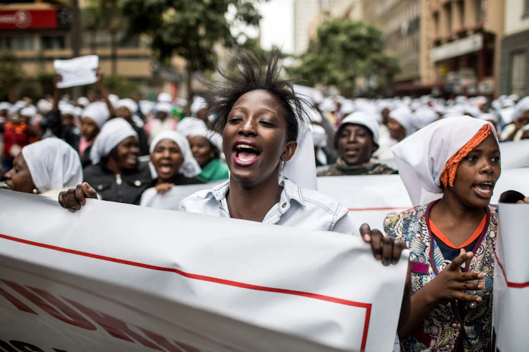 Women in white head scarves demonstrating