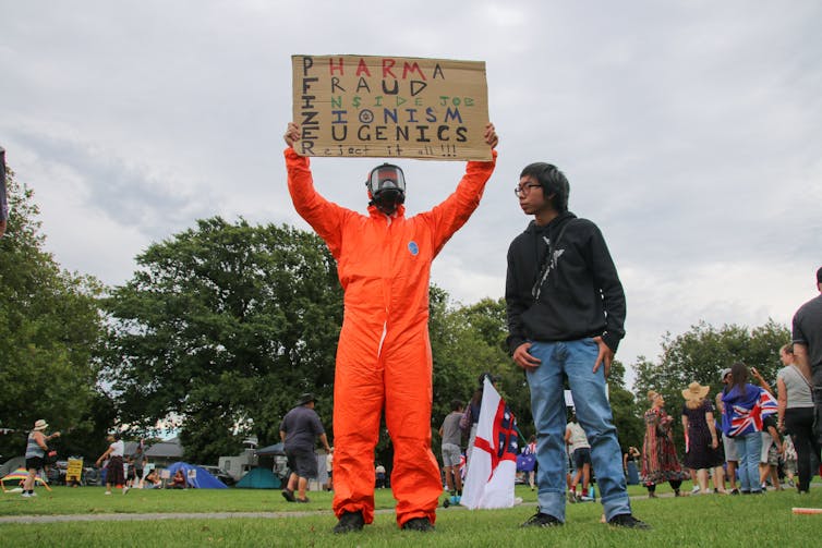 A protester in a bio-hazard suit