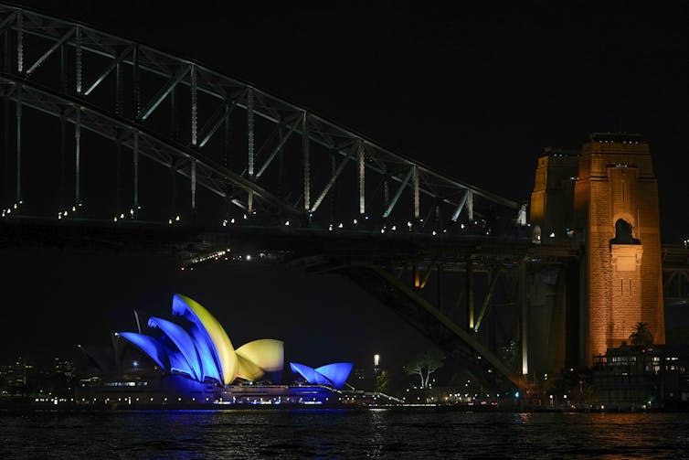 The Opera House sails lit with the colours of Ukraine's national flag