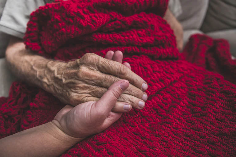person holding older person's hand