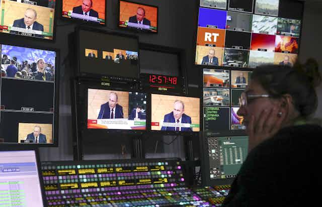 A technician watches multiple screens in RT's broadcast control room.