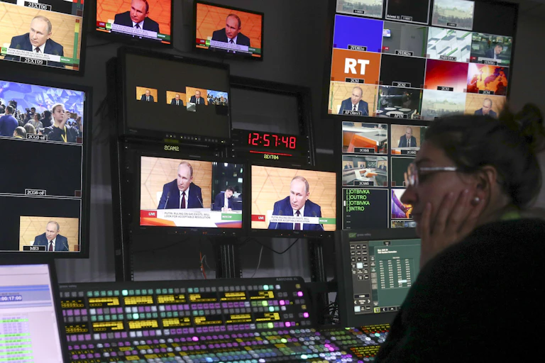 A technician watches multiple screens in RT's broadcast control room.