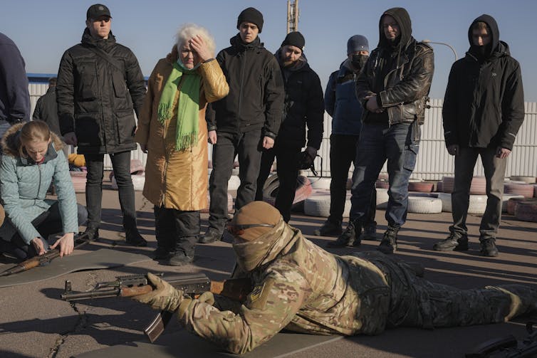 A group of civilians learn how to handle weapons from members of far-right militias.