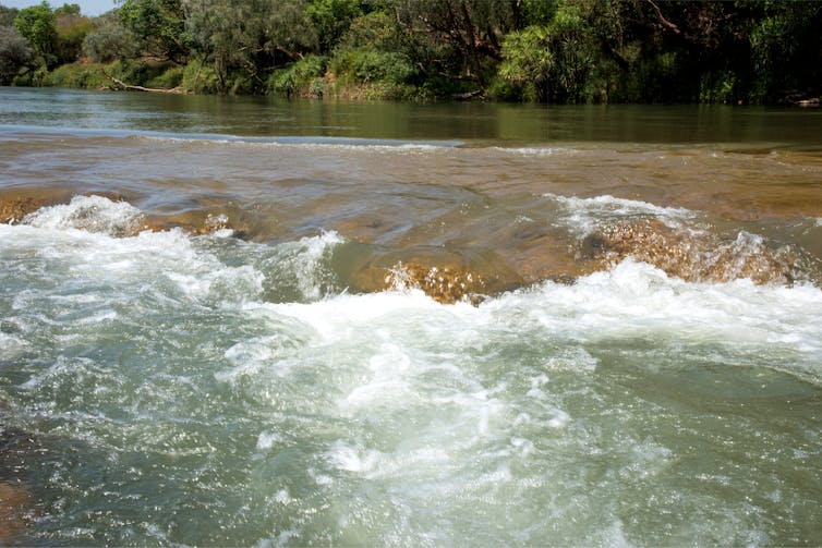 water runs over rocks in river