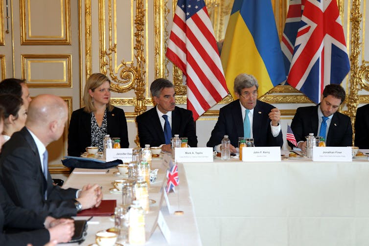 US secretary of state John Kerry sits at a table with other diplomats including Ukrainian foreign minister Andrii Deshchytsia and British foreign secretary William Hague, March 2014.