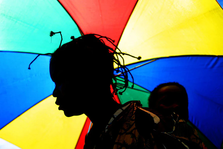 A woman carrying a baby on her back