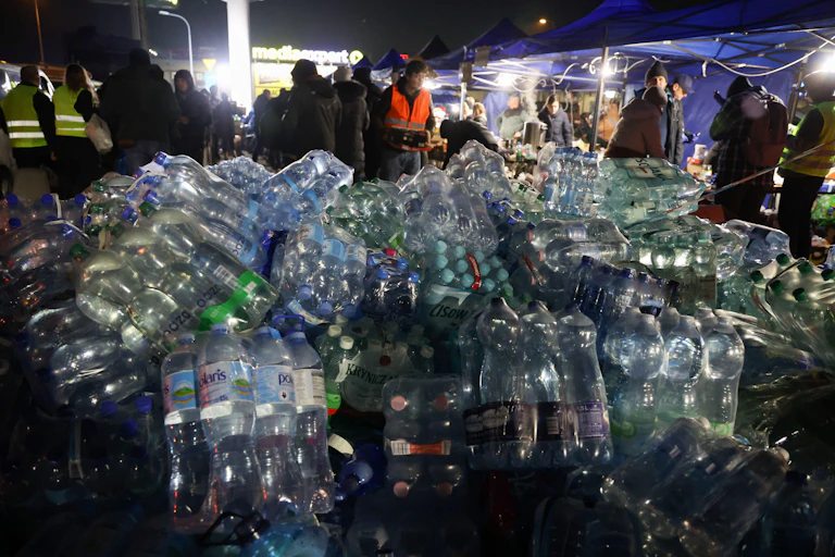 Crates of bottled water in a parking lot in Poland, dstined for Ukrainian refugees.