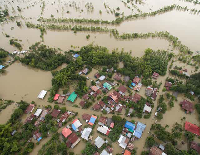 Aerial view of houses surrounded by floodwater. 