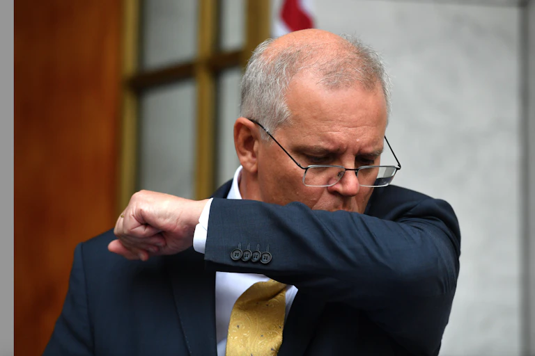 PM Scott Morrison coughing into his elbow