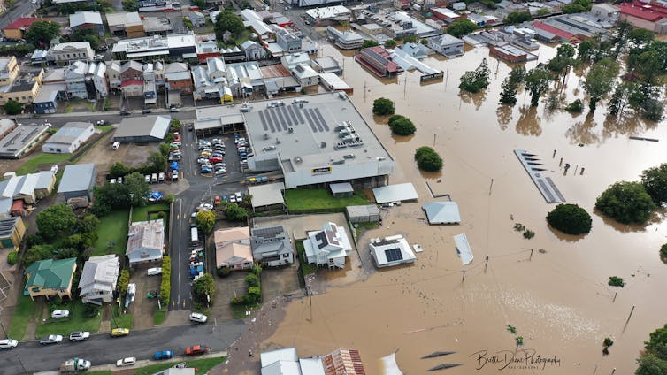 aerial view of brown flood water and built structures