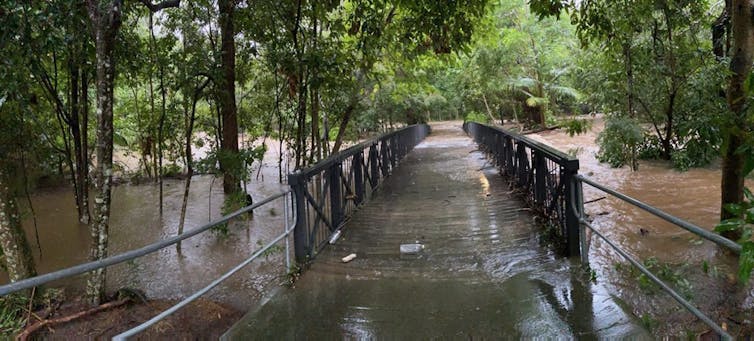 bridge over creek submerged by water