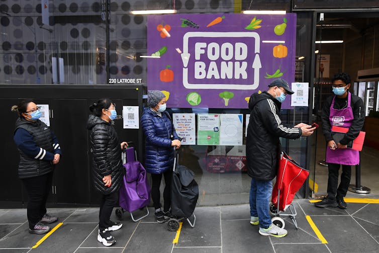 A queue of people waiting at the food bank