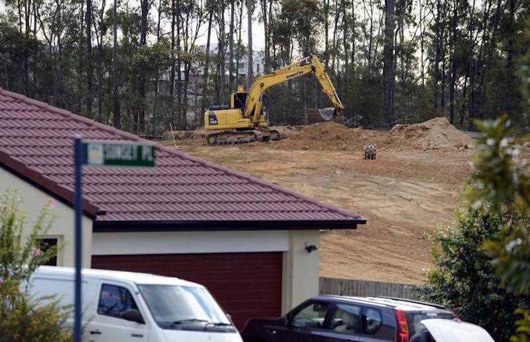 new home beside cleared lot