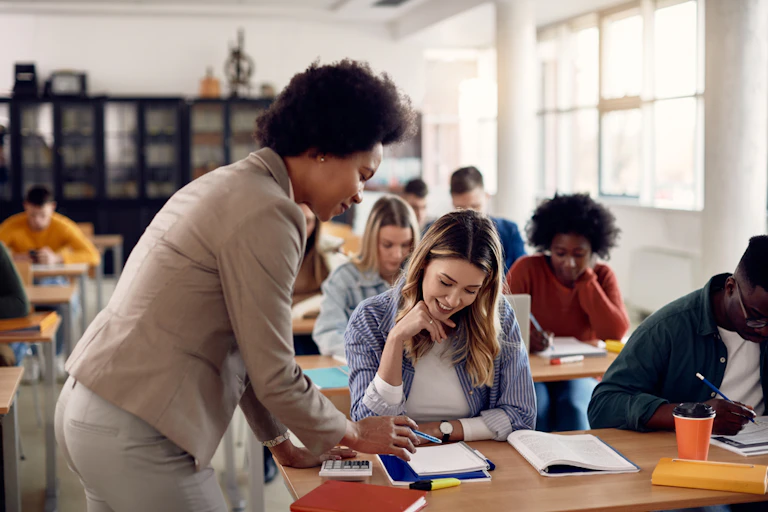 A lecturer assisting her students in class.