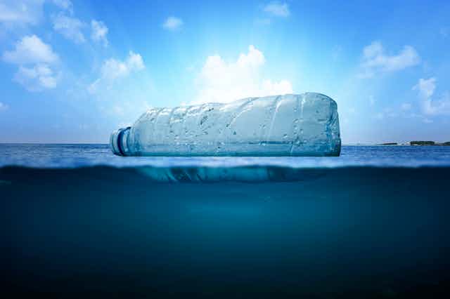 A plastic bottle floating on the ocean surface.