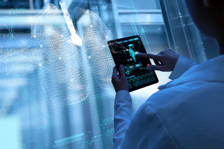 someone holding an ipad with a diagram of the human body stands in front of a holographic screen showing lungs