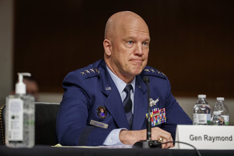 a U.S. general sits at a table