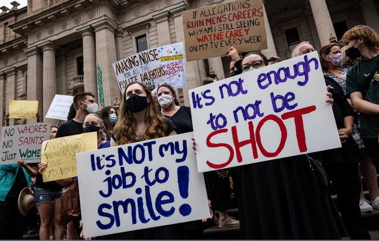 Women holding placards protesting violence against women