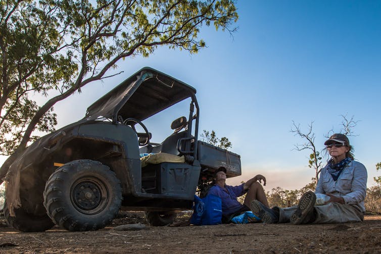 conservationists rest near the vehicle