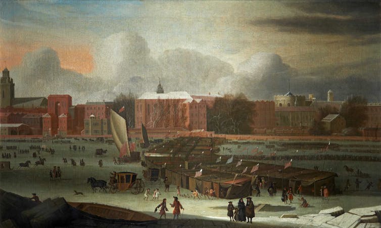 A painting of the River Thames frozen over and covered in wooden stalls, people and carriages.