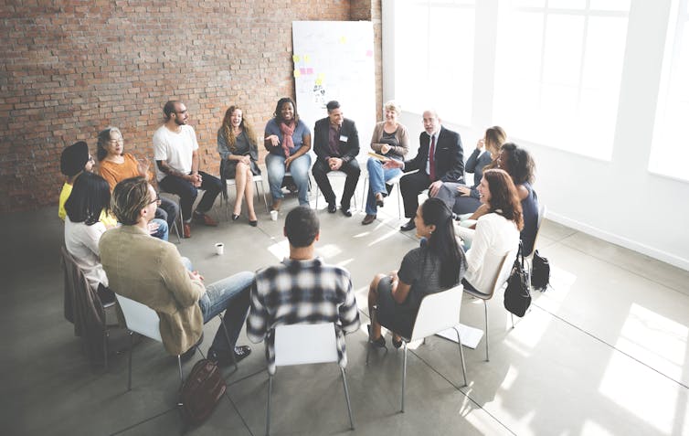 A group of people sitting in a circle.