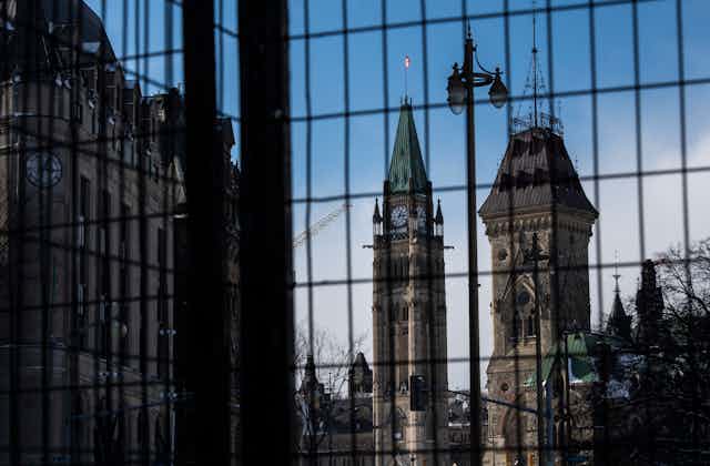 The Peace Tower is seen behind a police fence.
