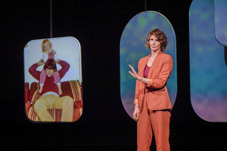 Production image: Beech talks about a photograph of a man with a young girl on his shoulders.