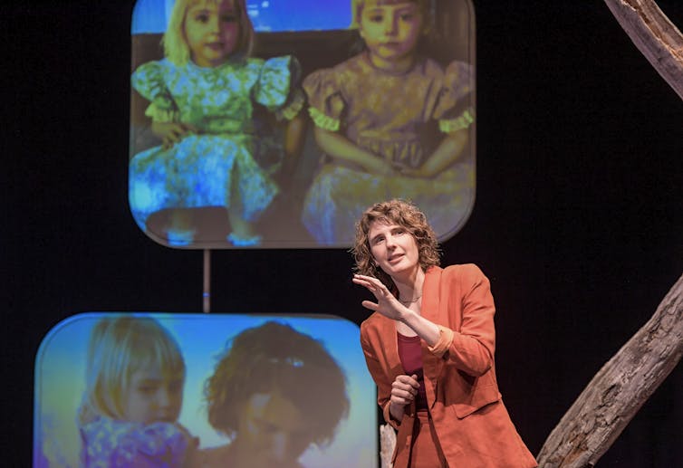 Production image: Beech in front of images of her triplets.
