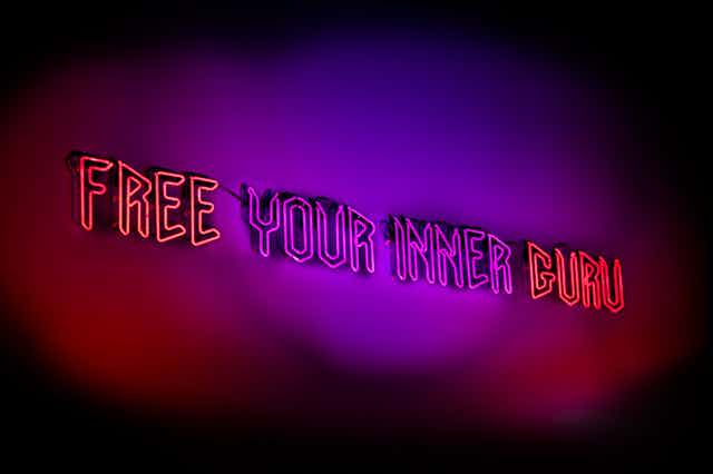 Neon text reads: free your inner guru