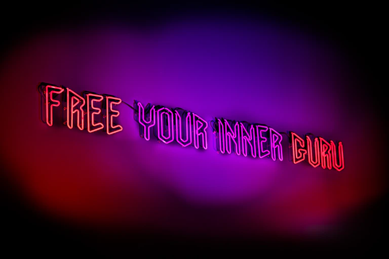 Neon text reads: free your inner guru