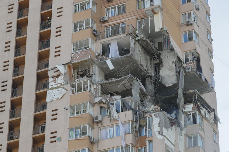 An apartment block that has been damaged by artillery fire.