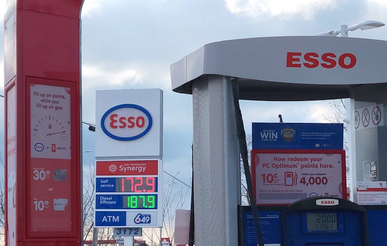 A gas station sign displaying prices.