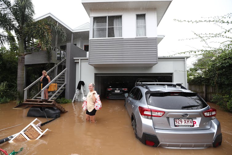 woman with flooded home and car