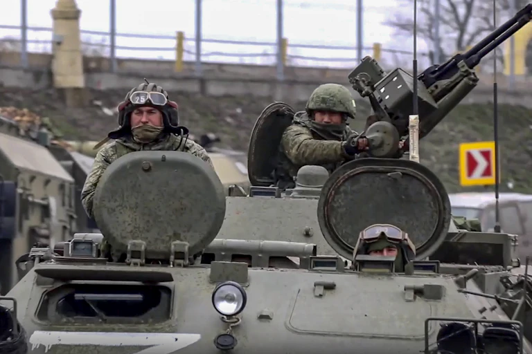 Two Russian servicemen driving armoured military vehicles