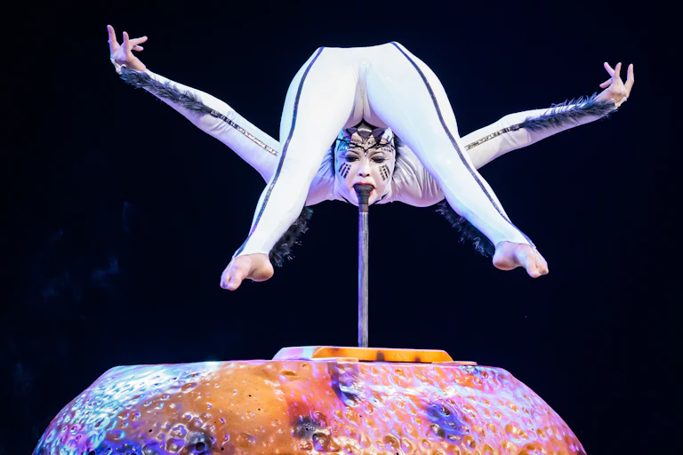 Circus contortionist bent double
