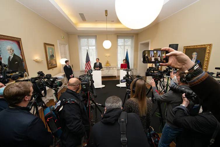 Press photographers and journalists at a press conference with US secretary of state, Antony Blinken, and Estonian prime minister, Kaja Kallas.
