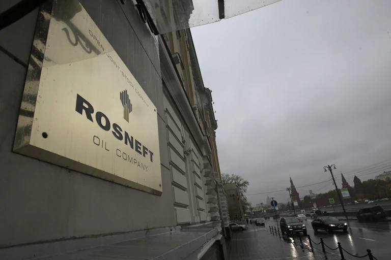 Metal plaque reading "Rosneft Oil company" on a stone building