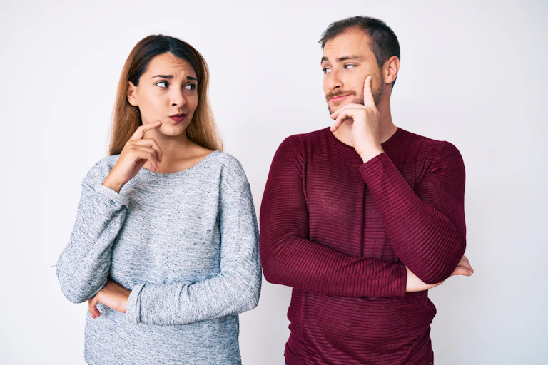Man looking smug while woman looks doubtful