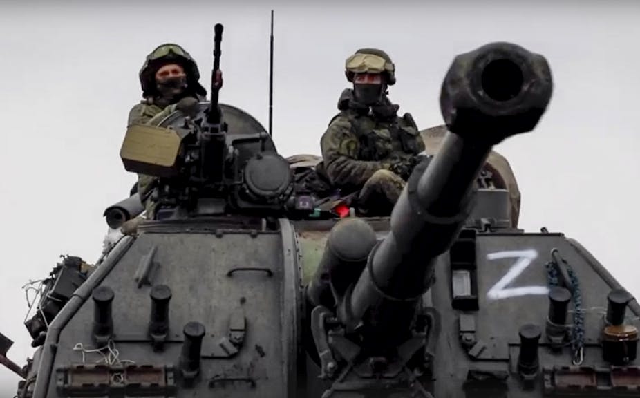 Russians driving a tank with a Z on the side