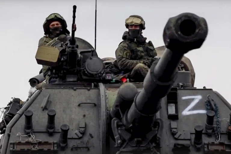 Russians driving a tank with a Z on the side