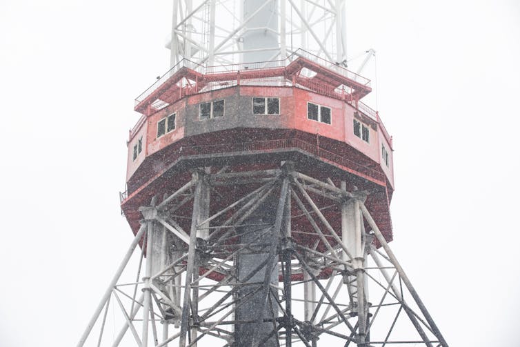 A partly damaged television tower.