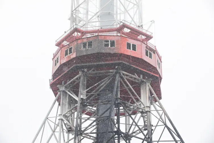 A partly damaged television tower.