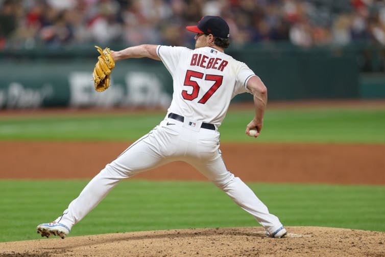 Baseball pitcher throws ball.