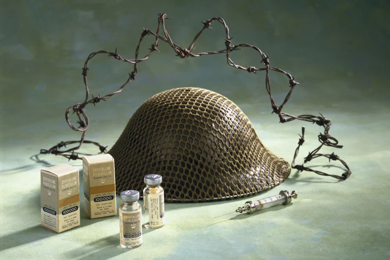 glass vials, syringe, helmet, barbed wire