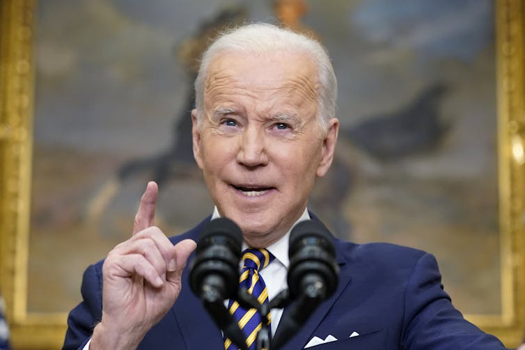 Biden raises a finger as he makes a point during his announcement to increase sanctions against Russia.