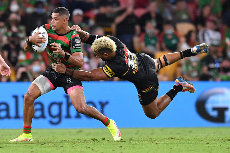 Rugby league player tackles an opponent